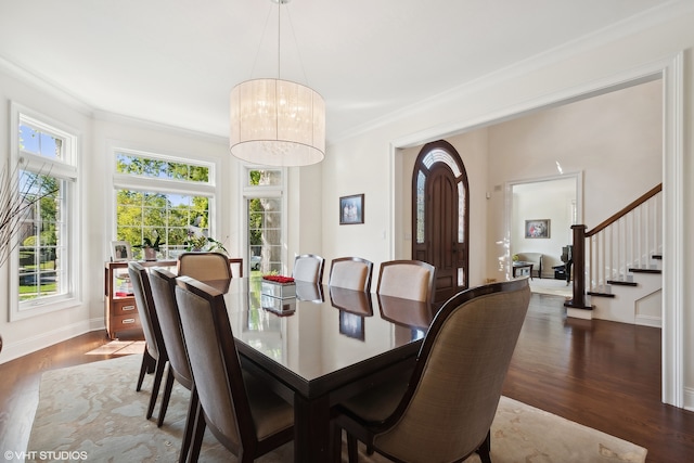 dining room featuring ornamental molding, a notable chandelier, and dark hardwood / wood-style floors