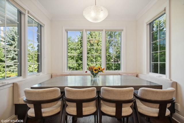 sunroom / solarium featuring breakfast area and a wealth of natural light