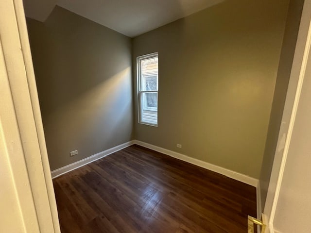 spare room featuring dark wood-type flooring