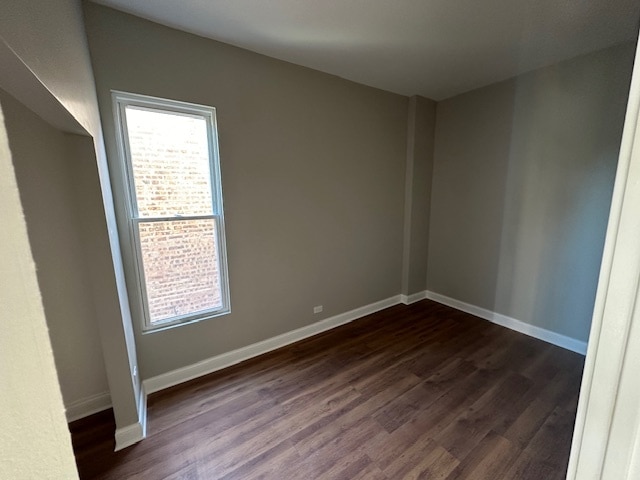 empty room with dark hardwood / wood-style floors