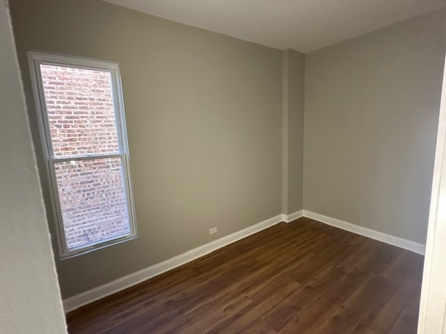 empty room featuring dark hardwood / wood-style flooring