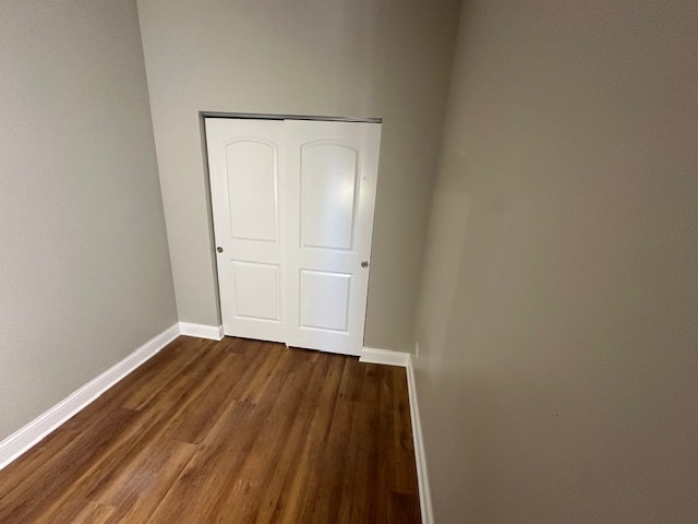 unfurnished bedroom featuring a closet and dark hardwood / wood-style flooring