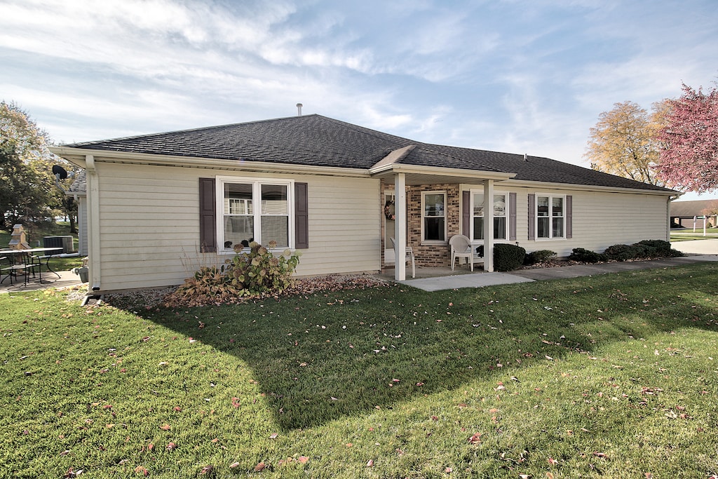 back of house with a patio and a yard