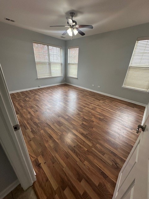 unfurnished room featuring ceiling fan and dark hardwood / wood-style floors