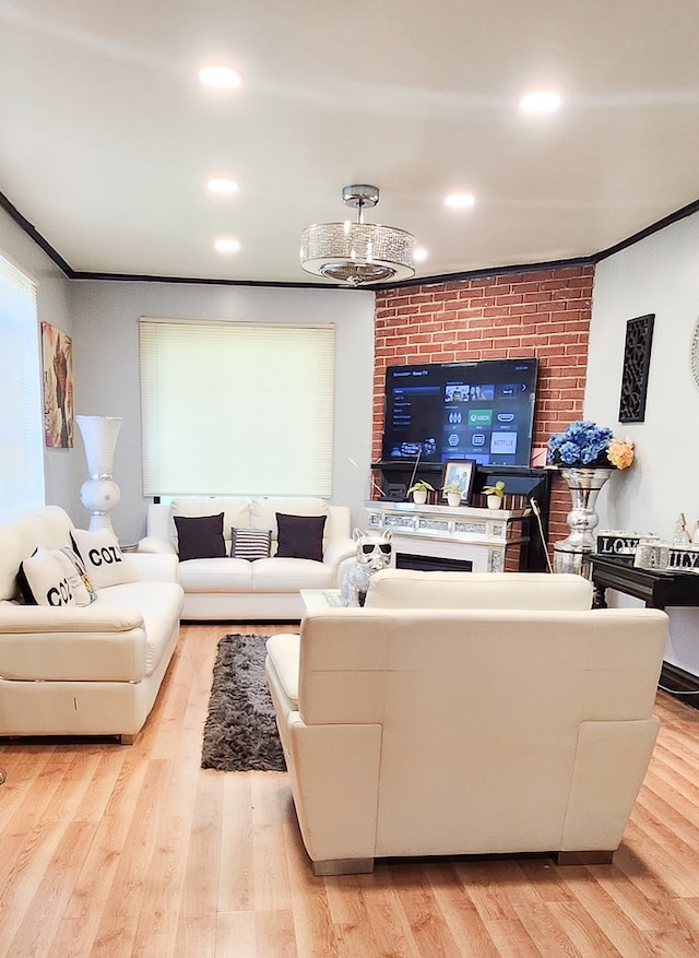 living room with crown molding and light hardwood / wood-style floors