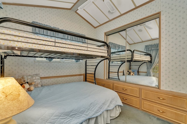 carpeted bedroom featuring a closet and vaulted ceiling