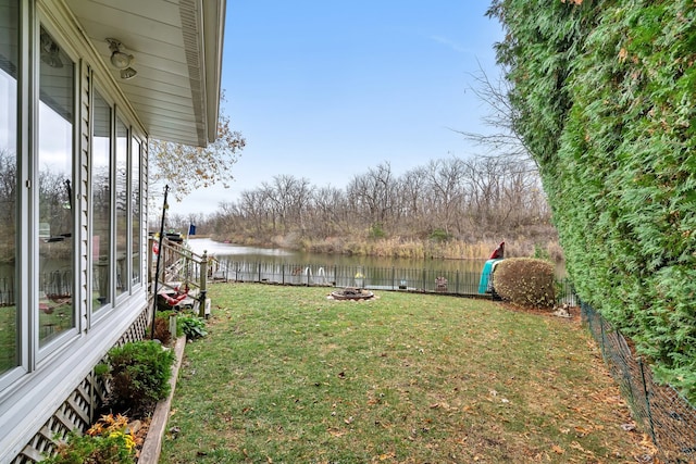 view of yard featuring a water view and an outdoor fire pit