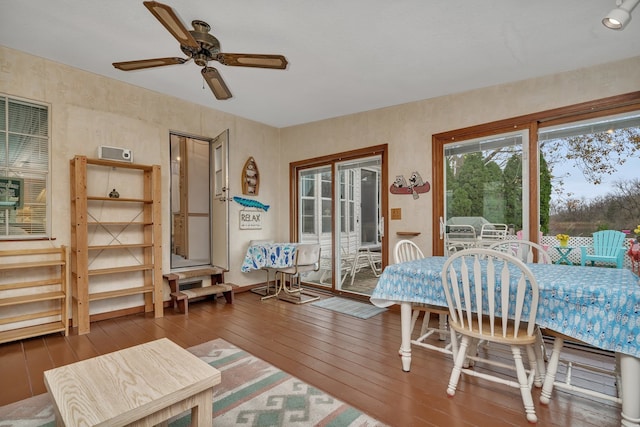 dining space featuring dark wood-type flooring and ceiling fan