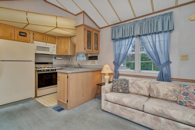 kitchen with white appliances, light carpet, backsplash, and vaulted ceiling