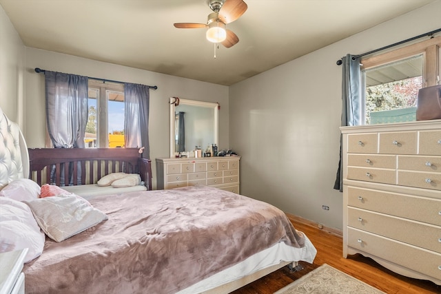 bedroom with hardwood / wood-style floors and ceiling fan