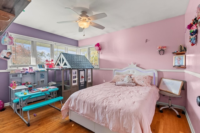 bedroom with ceiling fan and hardwood / wood-style flooring