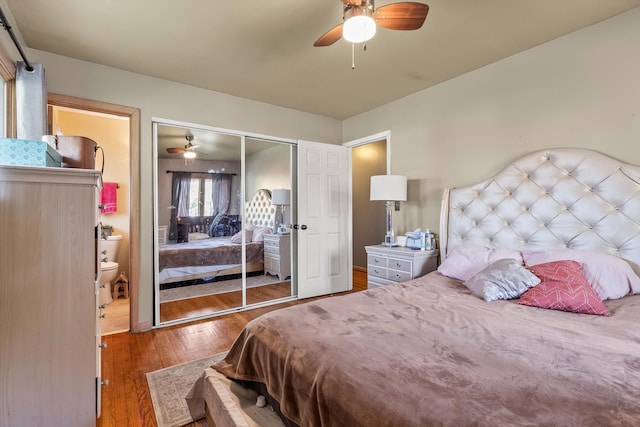 bedroom with dark hardwood / wood-style flooring, a closet, and ceiling fan