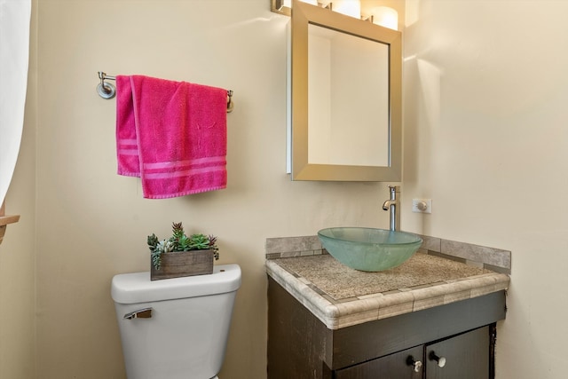 bathroom with toilet and vanity