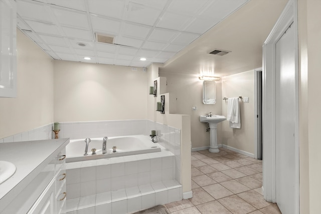 bathroom with vanity, tile patterned floors, and tiled tub