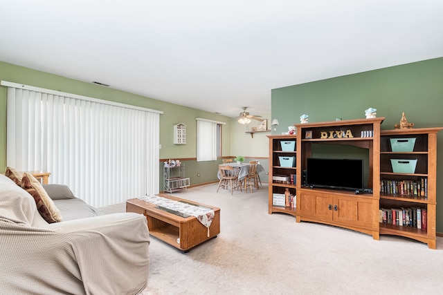 living room with carpet and ceiling fan