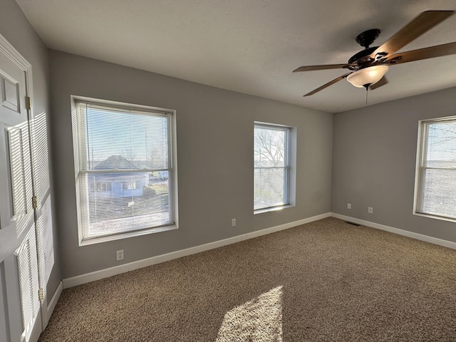 unfurnished room with carpet floors and ceiling fan