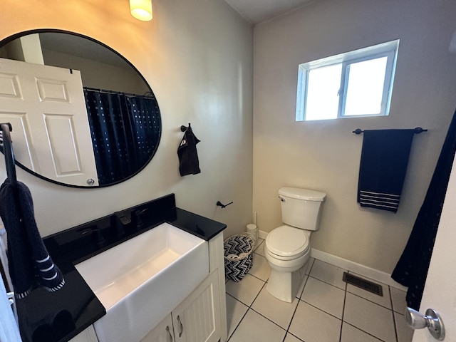 bathroom featuring tile patterned floors, vanity, and toilet