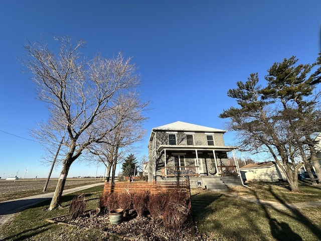 view of front of property with covered porch and a front yard