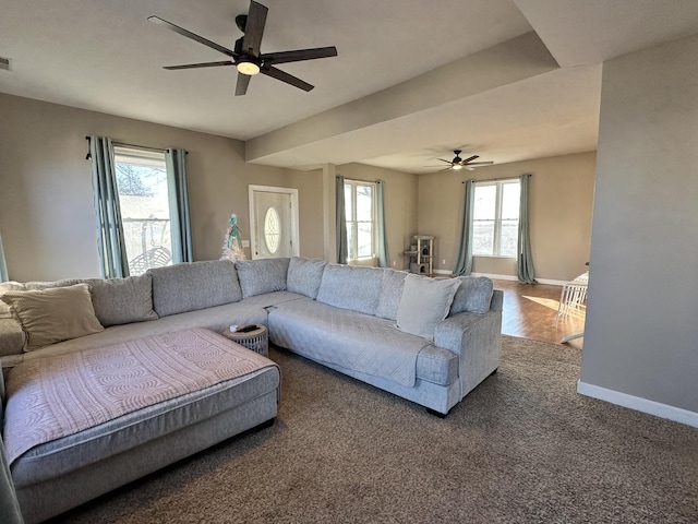 living room with dark carpet and ceiling fan