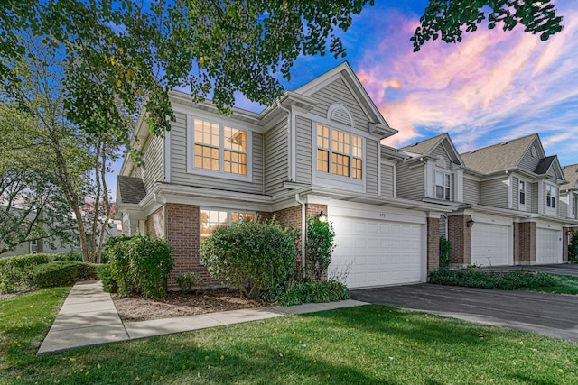 view of front of house featuring a lawn and a garage