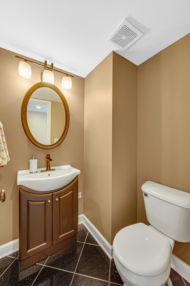 bathroom featuring toilet and vanity