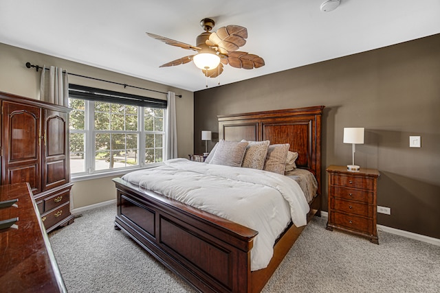 bedroom with ceiling fan and light colored carpet