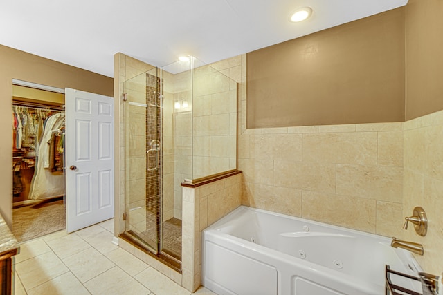 bathroom featuring independent shower and bath, tile patterned floors, and tile walls