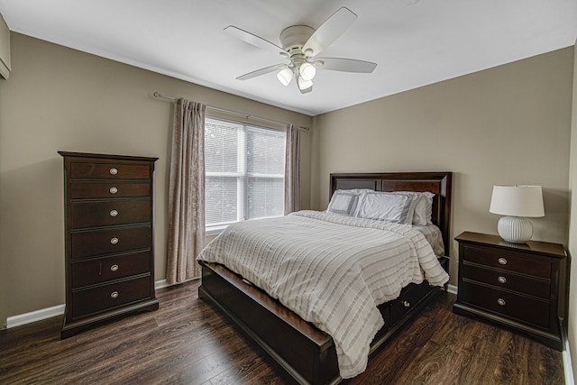 bedroom with dark hardwood / wood-style floors and ceiling fan