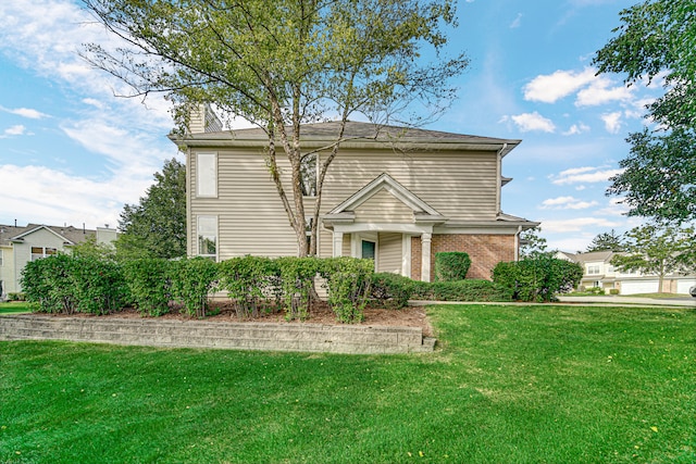 view of front of home featuring a front yard and a garage