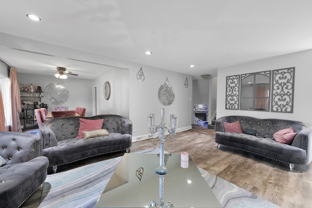 living room with hardwood / wood-style floors and ceiling fan