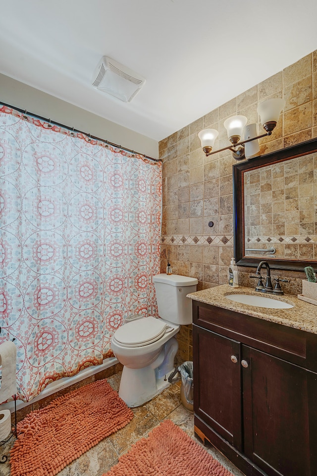 bathroom featuring vanity, toilet, tile walls, and curtained shower