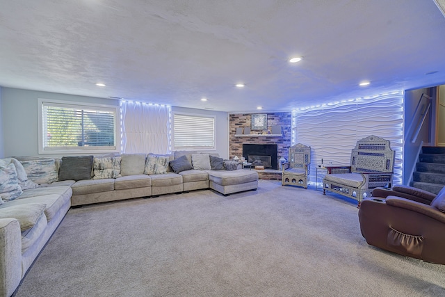 living room featuring carpet and a brick fireplace