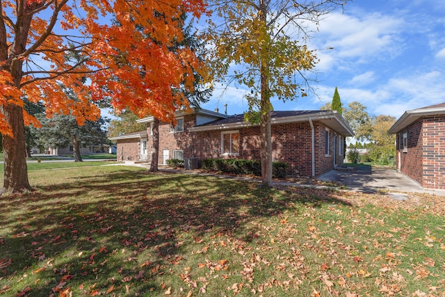 exterior space with a yard, a patio, and cooling unit