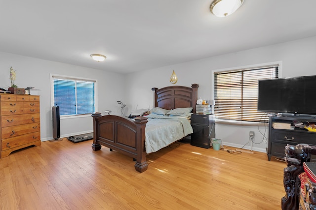 bedroom featuring light hardwood / wood-style floors and multiple windows