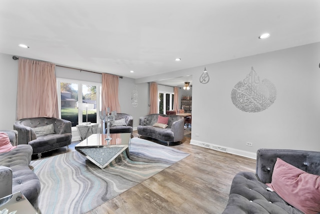 living room with hardwood / wood-style flooring and ceiling fan