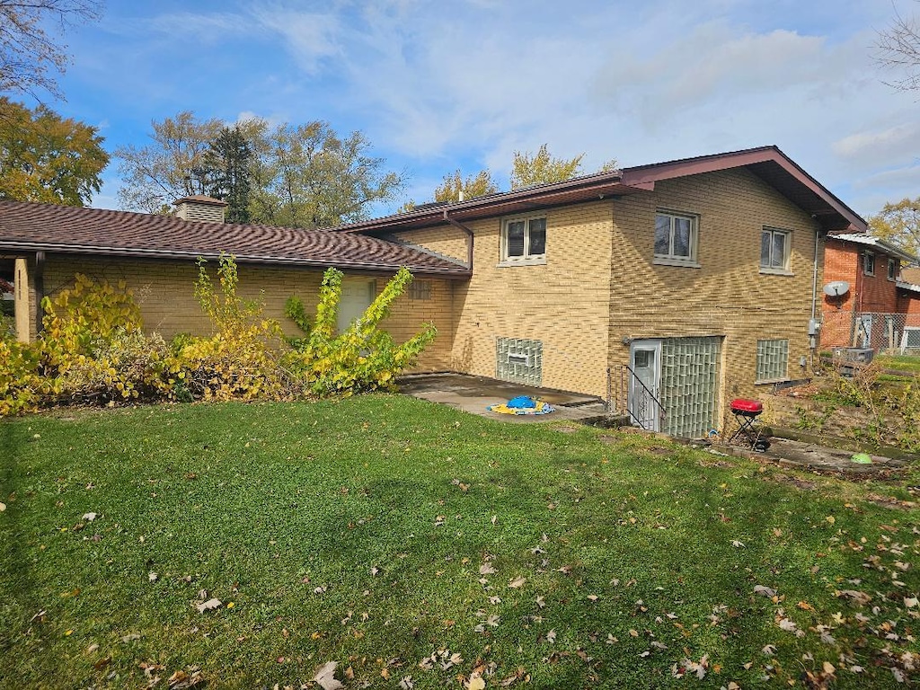 back of house featuring a yard and a patio