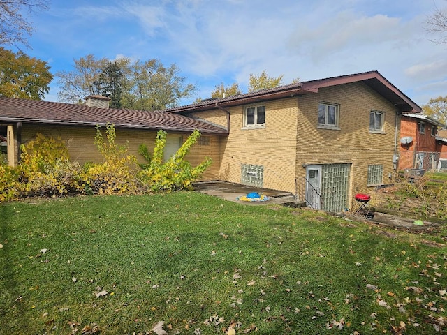 back of house featuring a yard and a patio