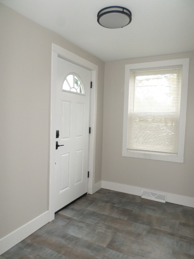 entryway with dark hardwood / wood-style flooring