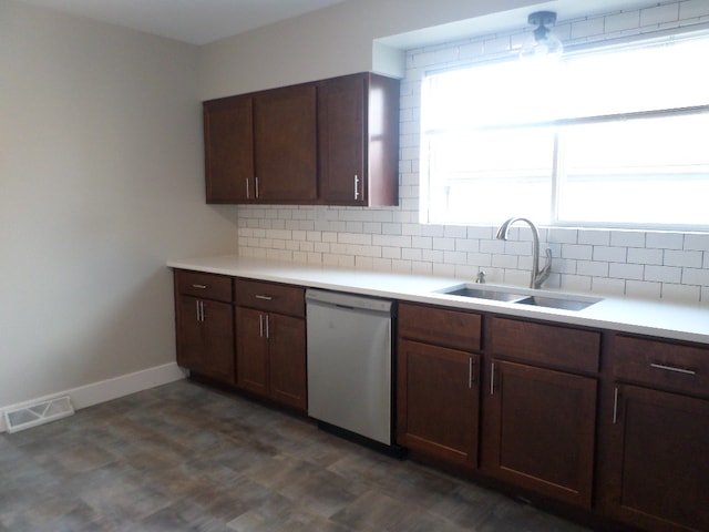 kitchen featuring dishwasher, dark brown cabinetry, sink, and backsplash