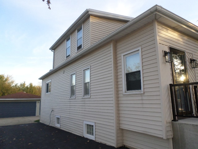 view of side of property featuring an outdoor structure and a garage