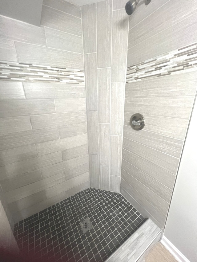 bathroom with a tile shower