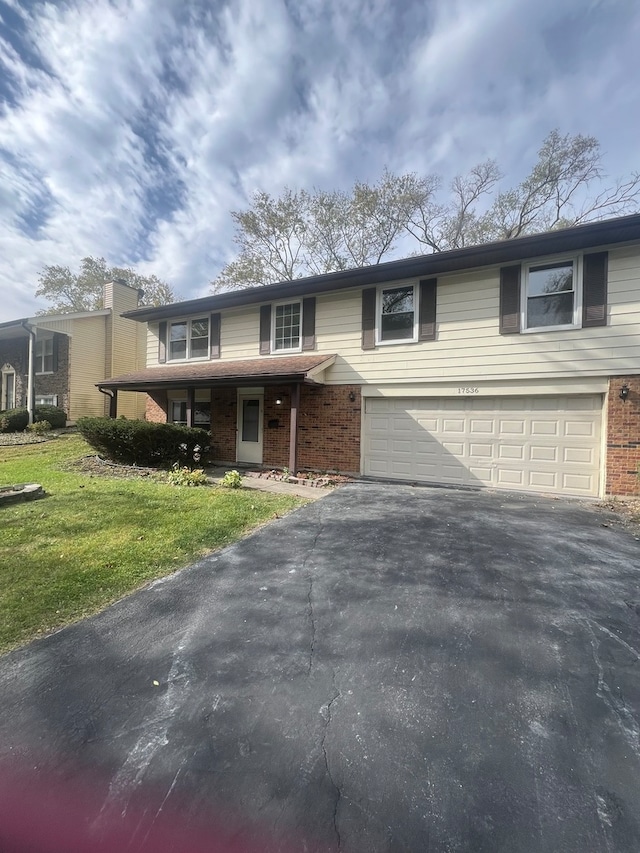 view of front of house with a front lawn and a garage