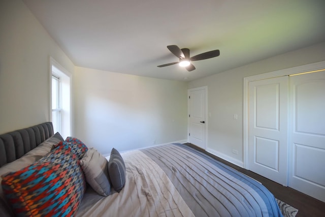 bedroom with a closet, ceiling fan, and dark hardwood / wood-style flooring