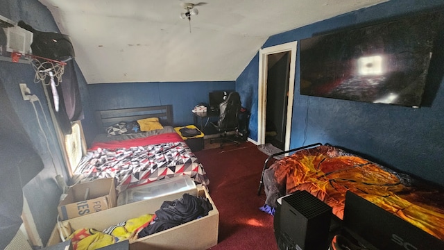 bedroom featuring dark carpet and lofted ceiling