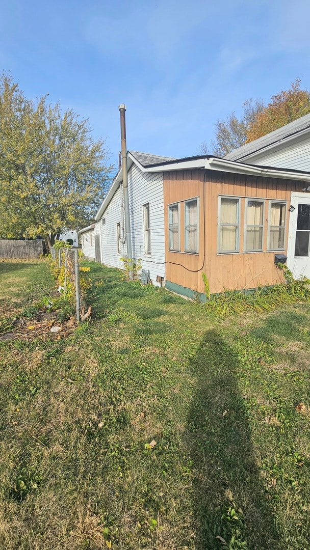 view of side of property with a yard