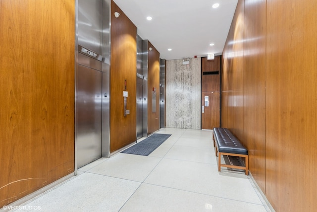 hallway with wood walls