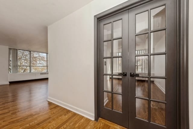 doorway featuring french doors and hardwood / wood-style flooring