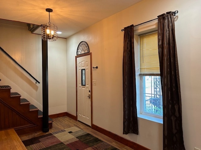 entrance foyer with dark wood-type flooring and a notable chandelier