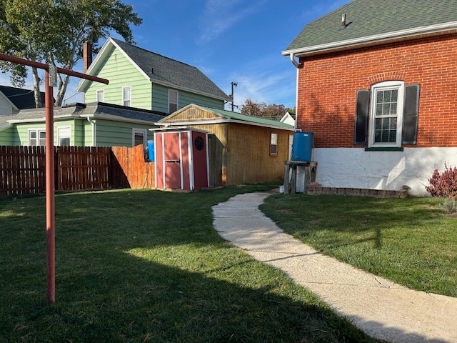 exterior space with a storage shed and a yard