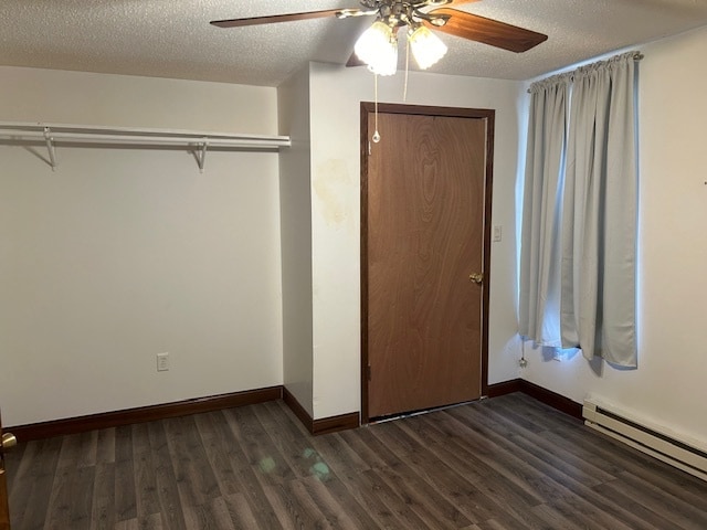 unfurnished bedroom featuring dark hardwood / wood-style floors, baseboard heating, a textured ceiling, and ceiling fan